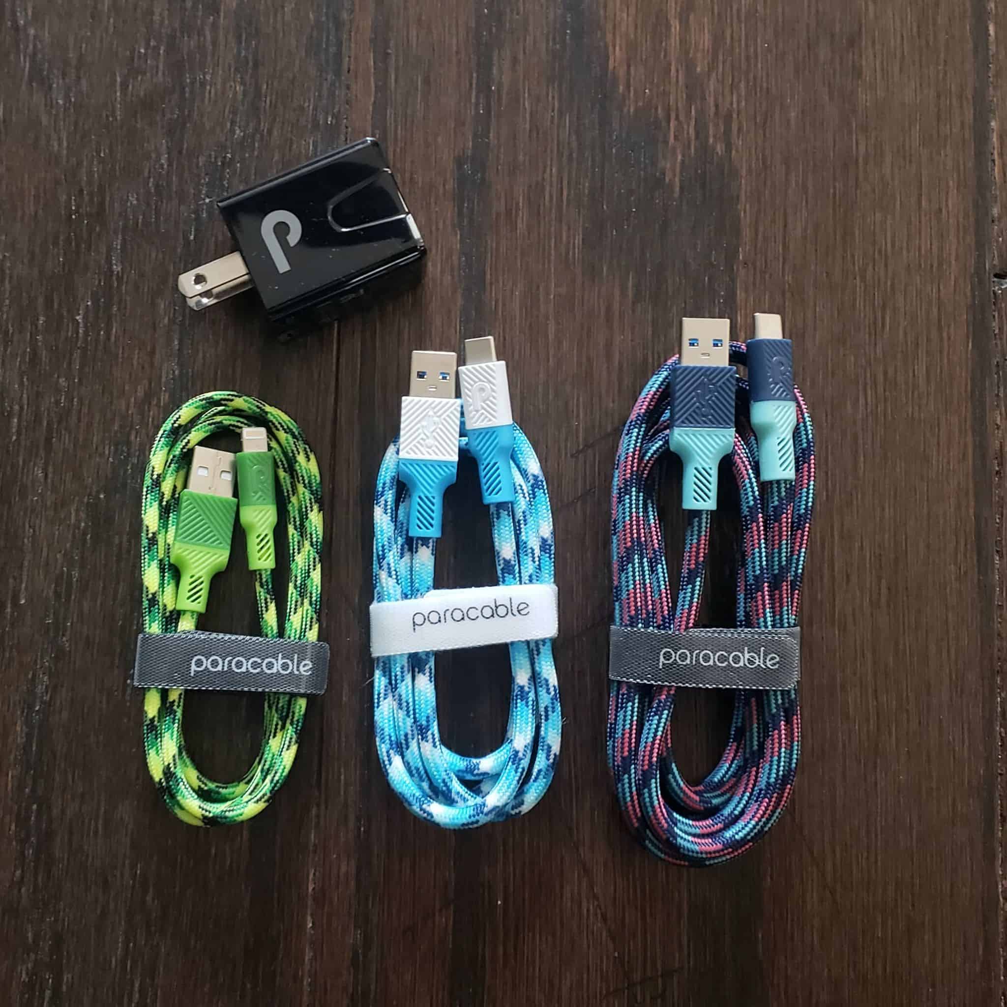 A green, baby blue and multicolored paracable cords with outlet adapter