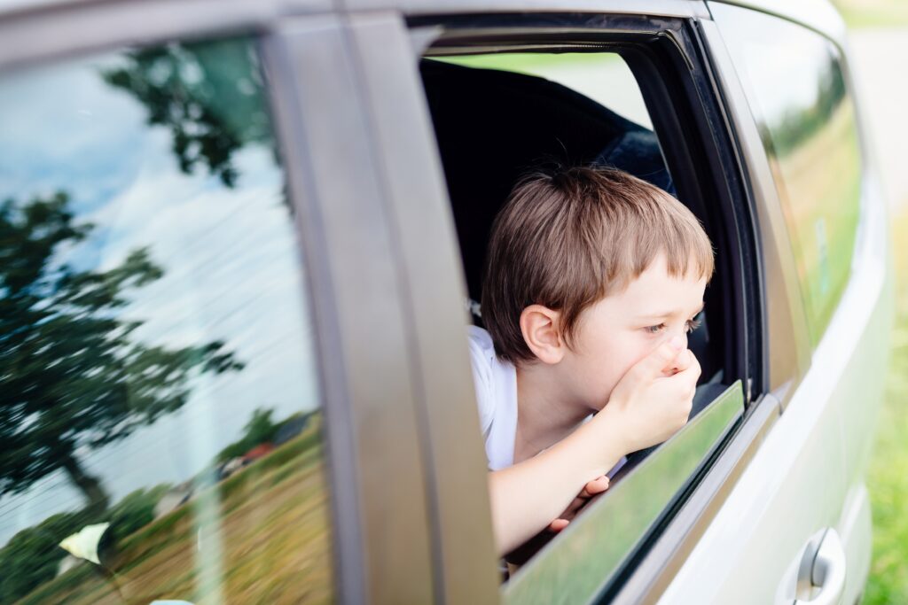 car sick kid with an open window