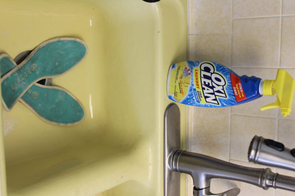 rothys in the sink with oxiclean spray nearby