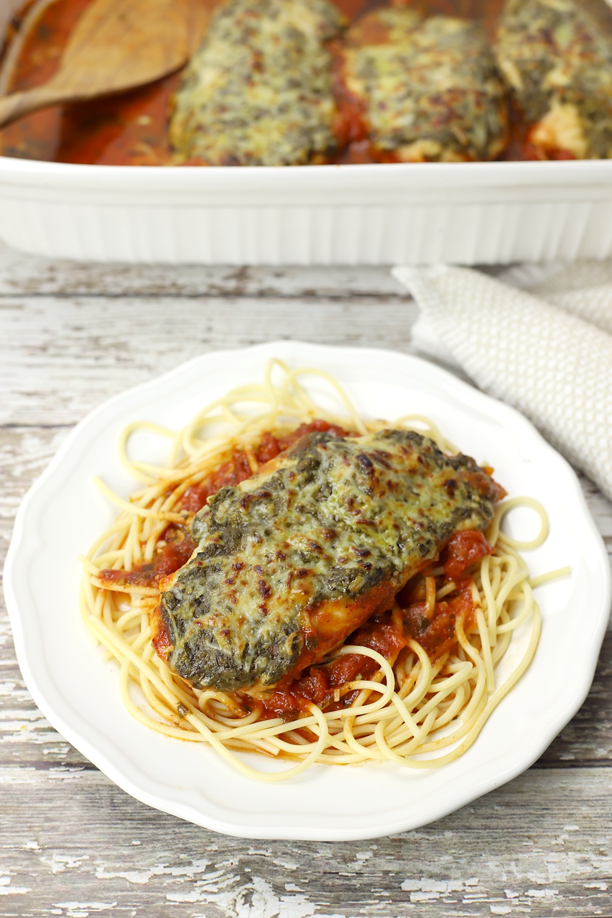 pesto mozzarella chicken on top of pasta