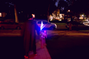 family playing with glow stick light sabers