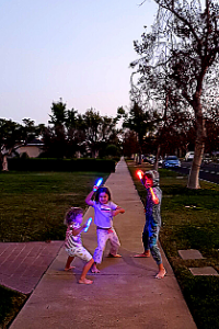 kids taking a walk with glow sticks