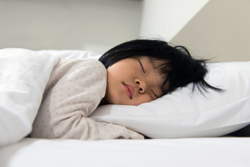 little girl sleeping on a pillow