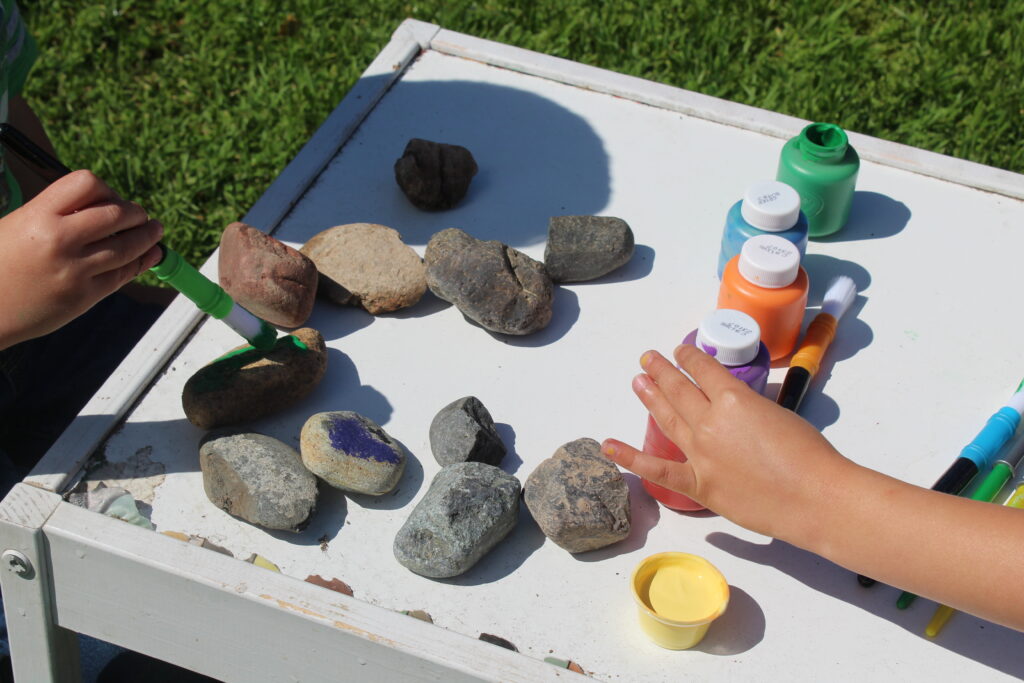 kids painting rocks rainbow colors