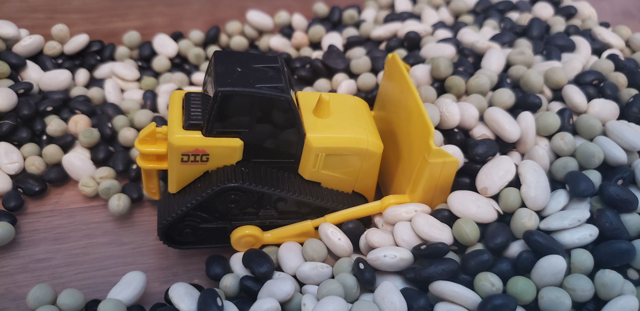 bulldozer in construction sensory bin filled with beans