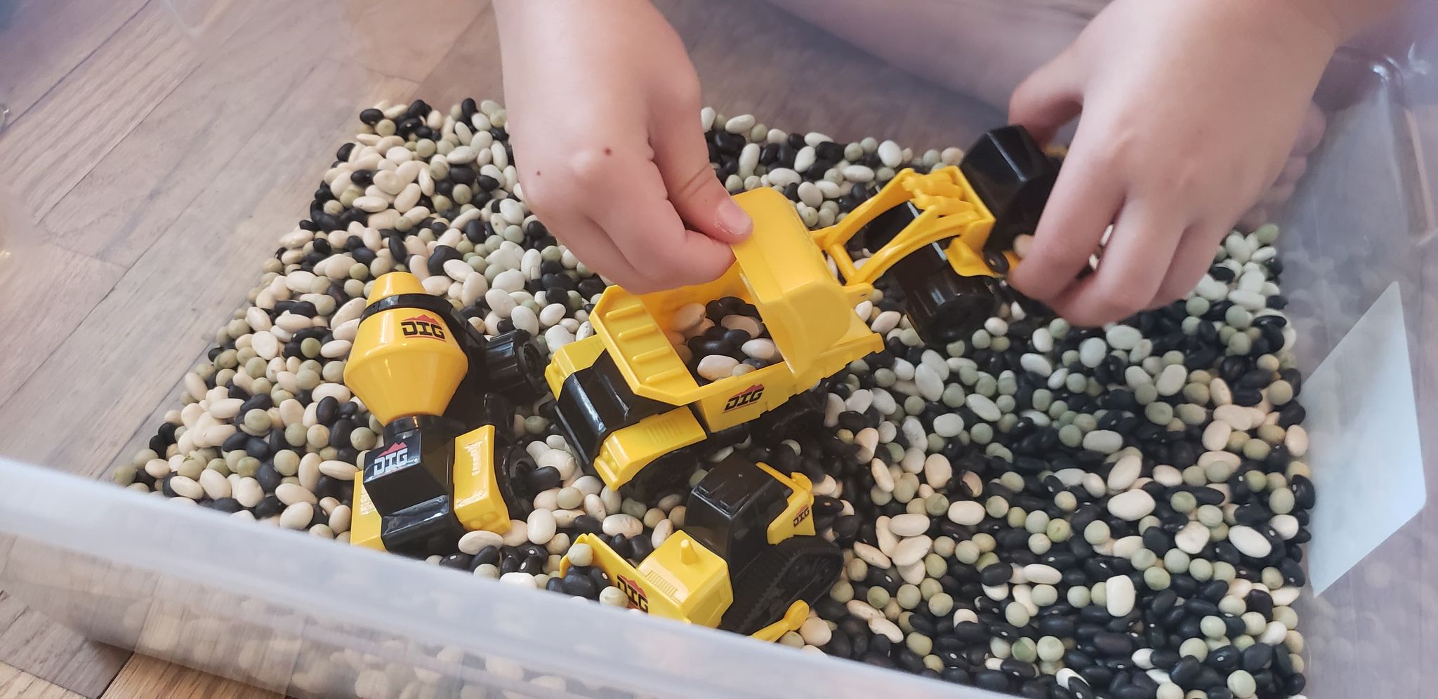 Construction site sensory bin with kinetic sand fill. Build, truck, pile,  stack, move and drive all around the…