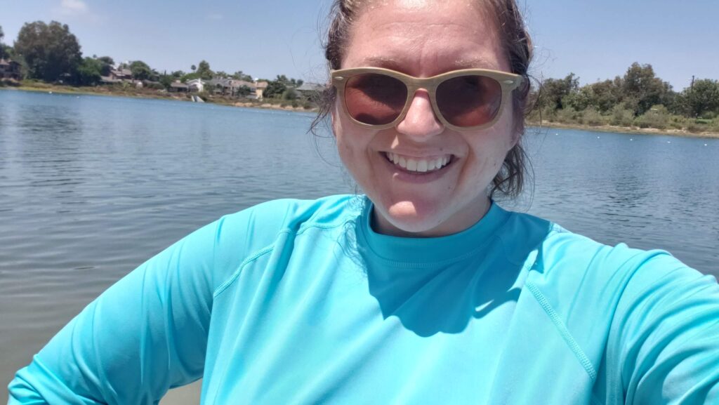 woman at beach in rash guard