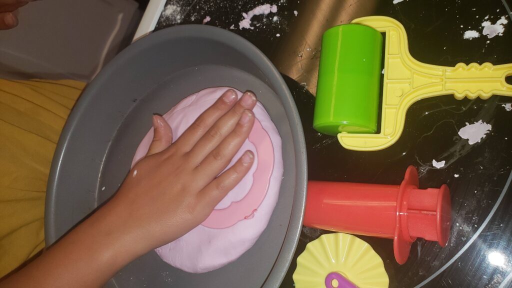 child playing with lavender cloud dough