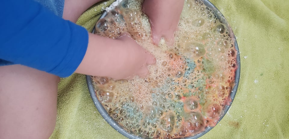 child playing with baking soda and vinegar