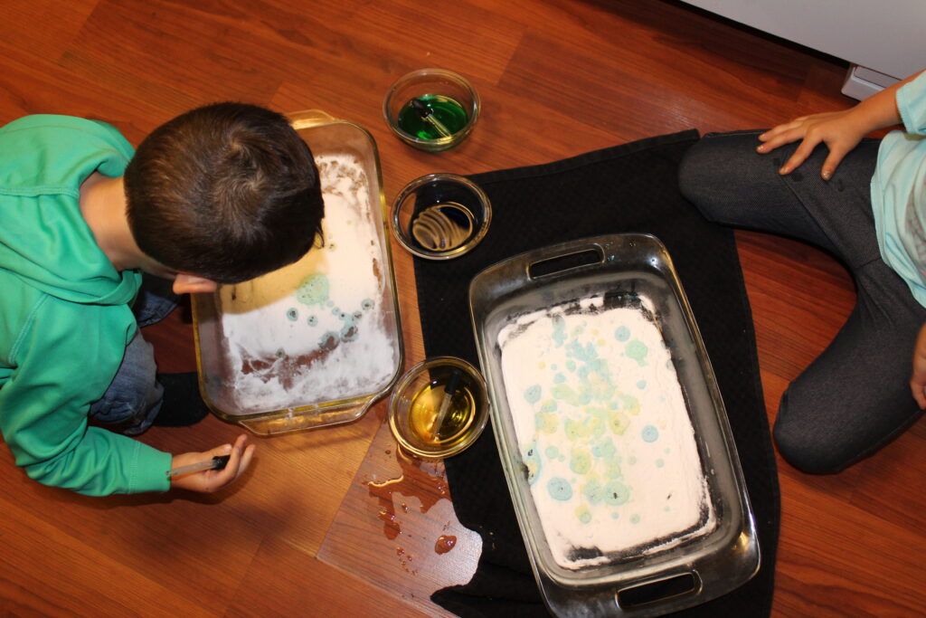 kids making a mess with baking soda and vinegar