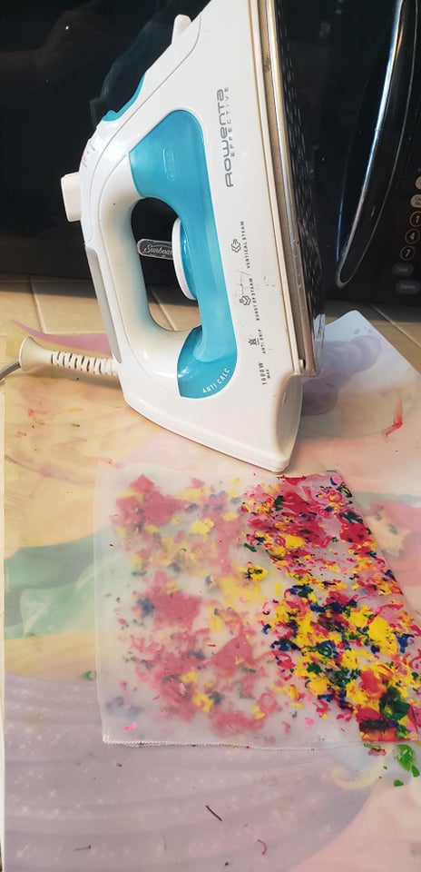 an iron next to melted crayon shavings