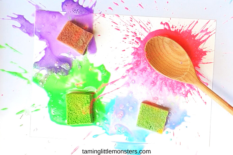 a spoon hitting a paint filled sponge