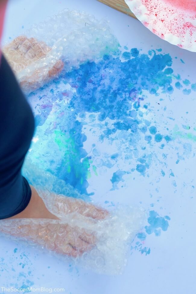 feet wrapped in bubble wrap, stomping in paint