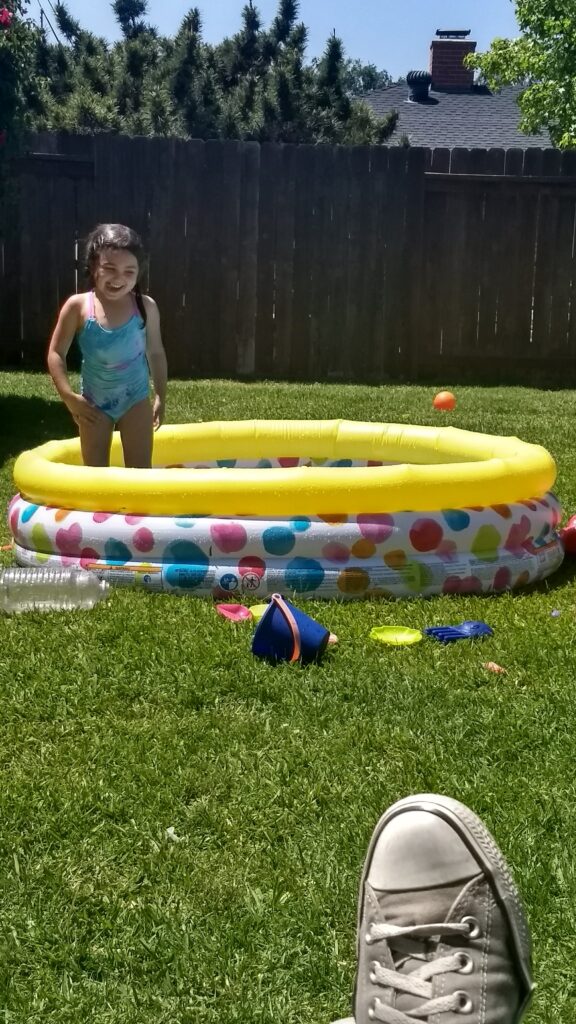 toddler in kiddie pool