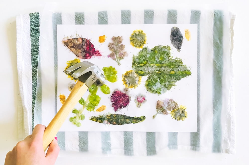 a hammer smashing leaves and flowers