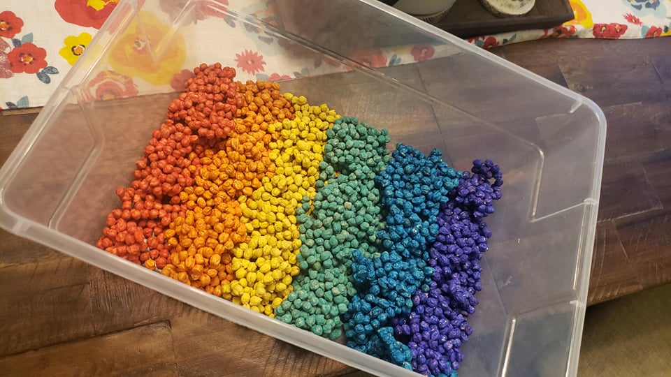 rainbow dyed chickpeas in a sensory bin