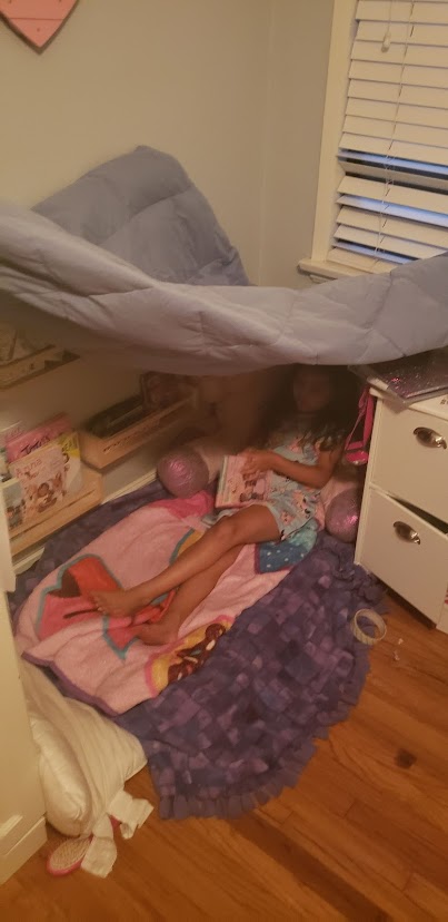 child made fort with sheets