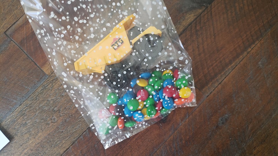 bag with M&Ms and mini construction truck inside