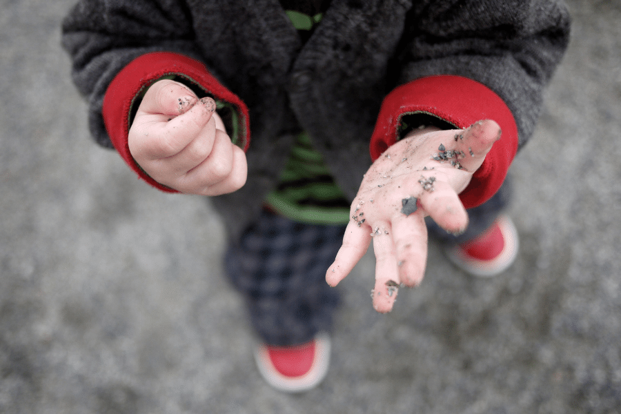 child with dirty hands