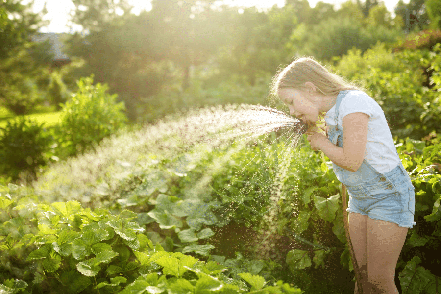 girl drinking from the hose