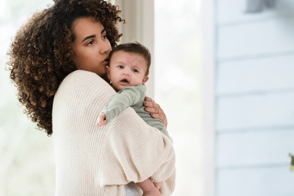 mom holding crying baby