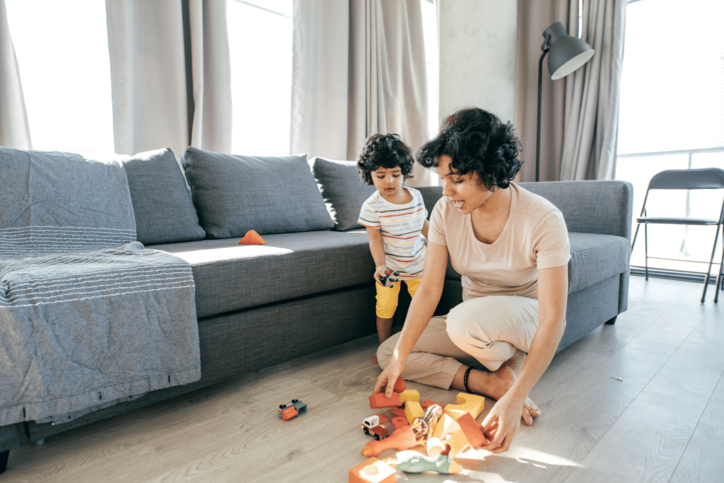 mom and child cleaning up toys