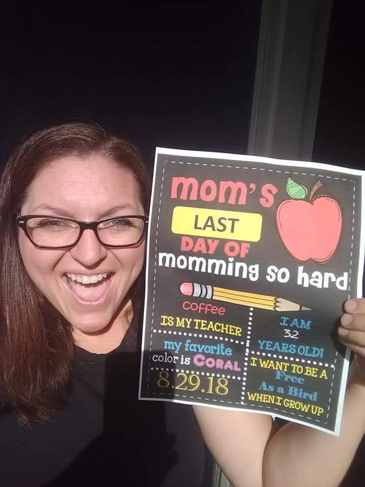 mom with first day of school sign