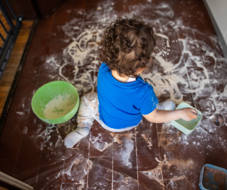 toddler playing in flour